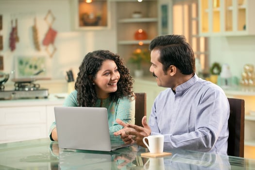 Smiling Couple While Surfing On Internet Using Laptop photo