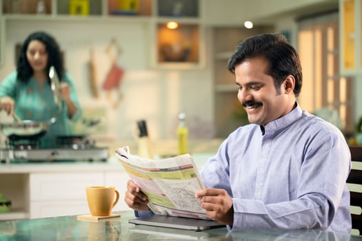 Man Reading Paper And Smiling photo