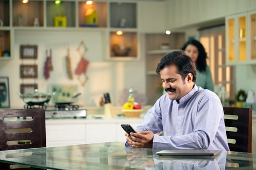 Man Typing On A Mobile Phone Sitting At The Home photo