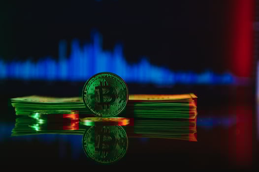 A symbolic coins of bitcoin on banknotes of dollars. Exchange bitcoin cash for a dollar. photo