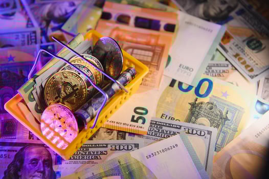 Close up heap of golden bitcoin physical coins on top of Euro, dollar banknotes background, high angle view, selective focus photo