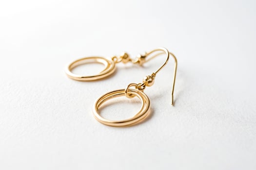 Gold Circle Earrings on White Background photo