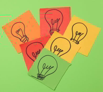 Drawn electric lamps on pieces of paper, the concept of searching for new solutions photo