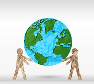 Two paper people holding a planet on a gray background, peace and saving the ecology of planet Earth photo