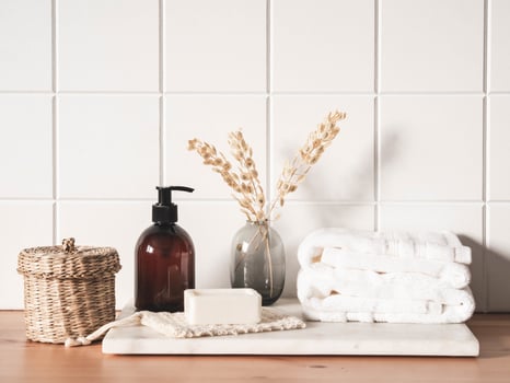 White bath background front view with cosmetic bottle and bath accessories photo
