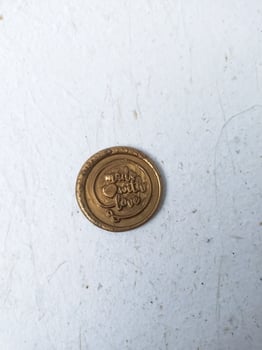 set of colorful wax coins on wooden background photo