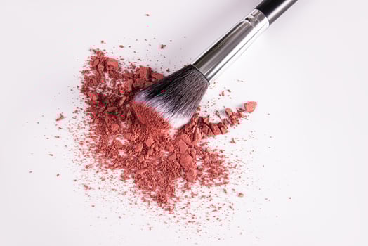 Chic loose blush in pink tone on a white background with a makeup brush. top view. close up view. Blush texture sample. decorative cosmetics. photo