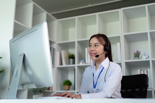 Call center woman asian in office for customer service, technical support and advice, contact and communication with employee operator in help desk agency photo