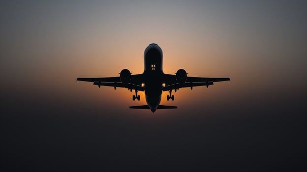 Monochrome airplane silhouette against a gradient sunset sky representing travel aspirations and dreamy voyages photo