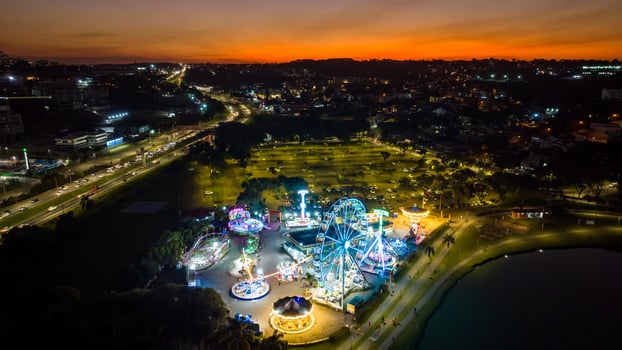 Curitiba in Parana, Brazil. Aerial View. Wonderful sunset with views of buildings and Tangua Park. Lake with reflection. photo