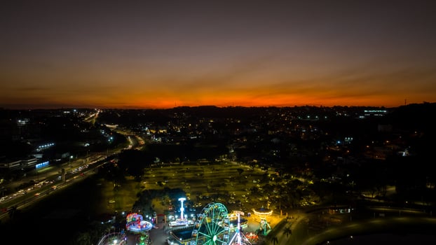 Curitiba in Parana, Brazil. Aerial View. Wonderful sunset with views of buildings and Tangua Park. Lake with reflection. photo