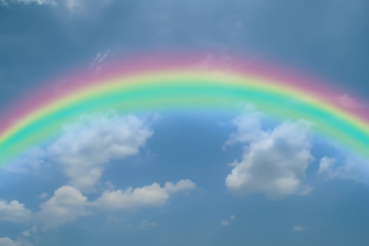 Scenic View, Rainbow Arches Across Clear Blue Sky photo