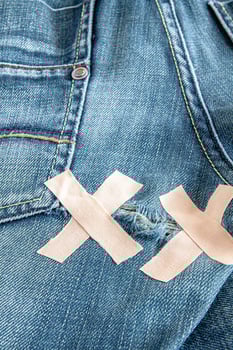 Ripped blue jeans at the back photo
