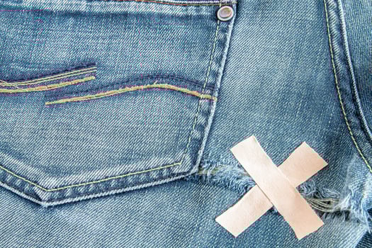 Ripped blue jeans at the back photo