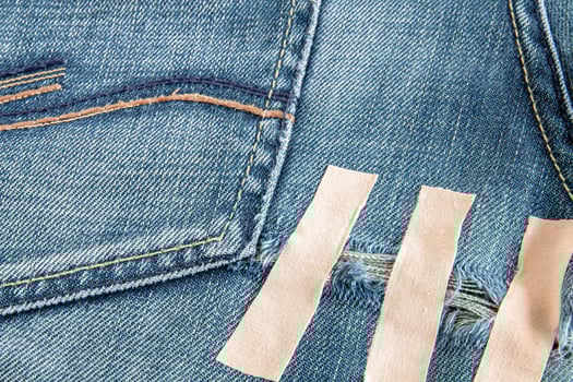 Ripped blue jeans at the back photo