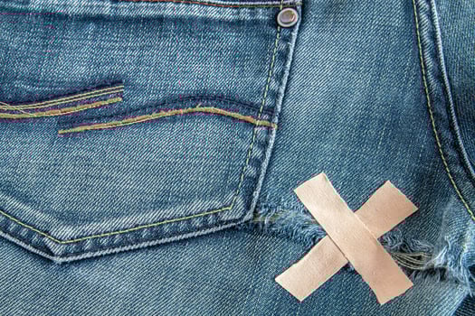 Ripped blue jeans at the back photo
