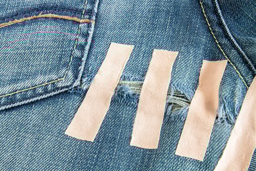 Ripped blue jeans at the back photo