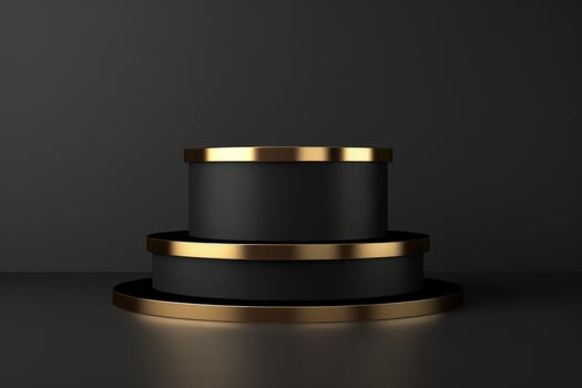 Three black round pedestals with gold detailing standing on each other on dark background photo