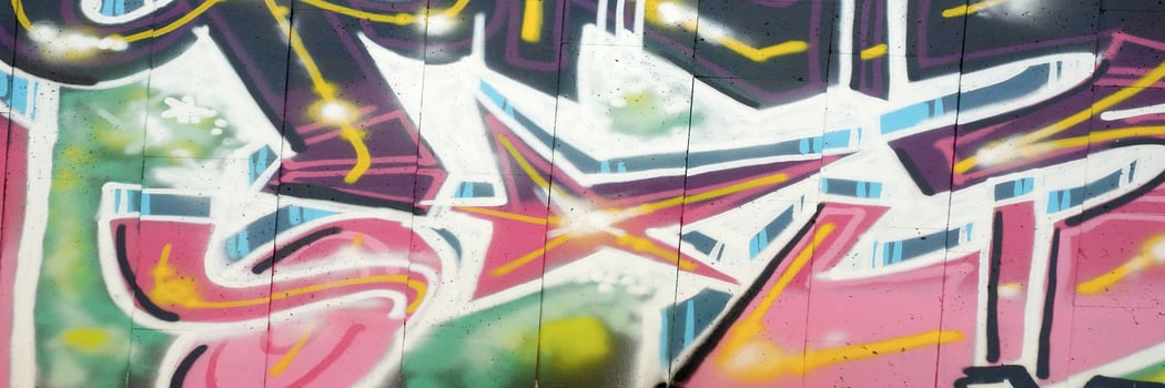 Colorful background of graffiti painting artwork with bright aerosol outlines on wall. Old school street art piece made with aerosol spray paint cans. Contemporary youth culture photo