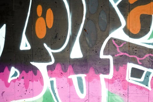 Colorful background of graffiti painting artwork with bright aerosol outlines on wall. Old school street art piece made with aerosol spray paint cans. Contemporary youth culture photo