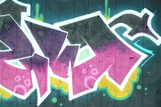 Colorful background of graffiti painting artwork with bright aerosol outlines on wall. Old school street art piece made with aerosol spray paint cans. Contemporary youth culture photo