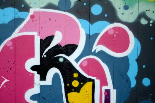 Colorful background of graffiti painting artwork with bright aerosol outlines on wall. Old school street art piece made with aerosol spray paint cans. Contemporary youth culture photo