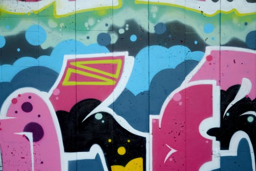 Colorful background of graffiti painting artwork with bright aerosol outlines on wall. Old school street art piece made with aerosol spray paint cans. Contemporary youth culture photo