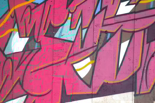 Colorful background of graffiti painting artwork with bright aerosol outlines on wall. Old school street art piece made with aerosol spray paint cans. Contemporary youth culture photo