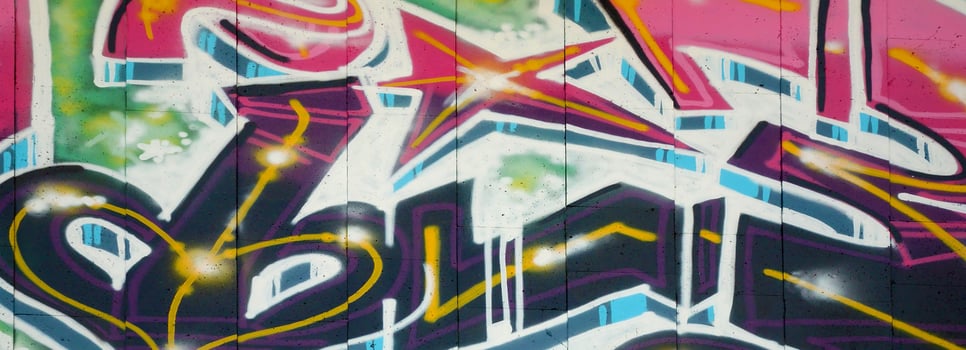 Colorful background of graffiti painting artwork with bright aerosol outlines on wall. Old school street art piece made with aerosol spray paint cans. Contemporary youth culture photo