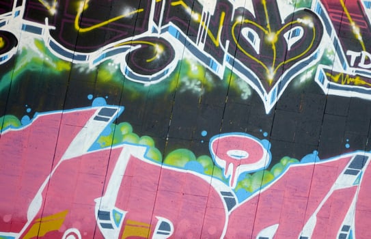 Colorful background of graffiti painting artwork with bright aerosol outlines on wall. Old school street art piece made with aerosol spray paint cans. Contemporary youth culture photo