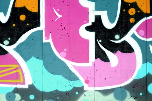 Colorful background of graffiti painting artwork with bright aerosol outlines on wall. Old school street art piece made with aerosol spray paint cans. Contemporary youth culture photo