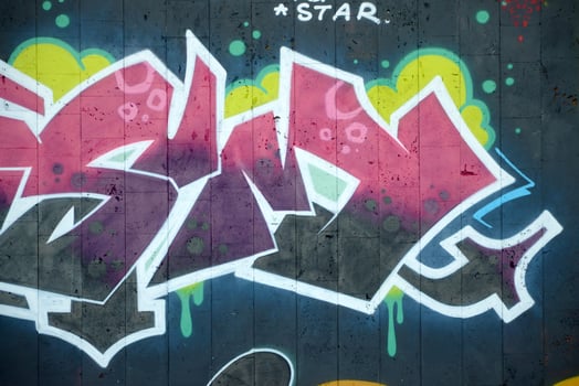 Colorful background of graffiti painting artwork with bright aerosol outlines on wall. Old school street art piece made with aerosol spray paint cans. Contemporary youth culture photo