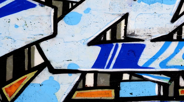 Colorful background of graffiti painting artwork with bright aerosol outlines on wall. Old school street art piece made with aerosol spray paint cans. Contemporary youth culture photo