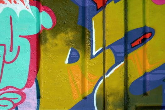 Colorful background of graffiti painting artwork with bright aerosol outlines on wall. Old school street art piece made with aerosol spray paint cans. Contemporary youth culture photo