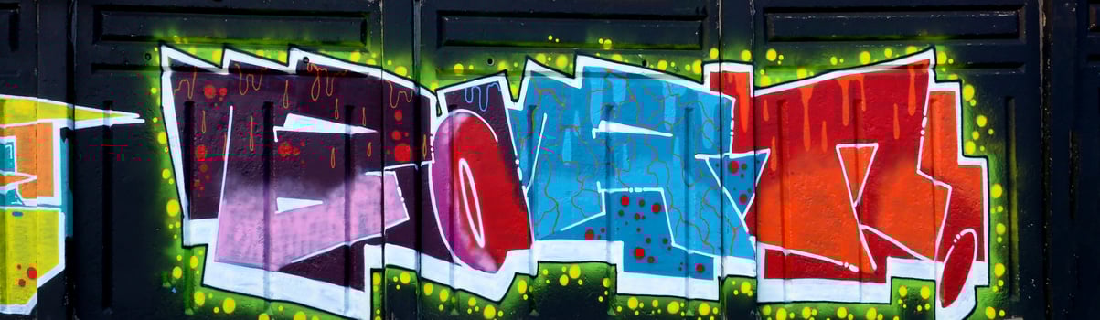 Colorful background of graffiti painting artwork with bright aerosol outlines on wall. Old school street art piece made with aerosol spray paint cans. Contemporary youth culture photo