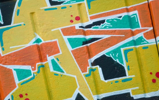 Colorful background of graffiti painting artwork with bright aerosol outlines on wall. Old school street art piece made with aerosol spray paint cans. Contemporary youth culture photo