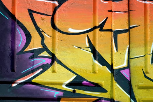 Colorful background of graffiti painting artwork with bright aerosol outlines on wall. Old school street art piece made with aerosol spray paint cans. Contemporary youth culture photo