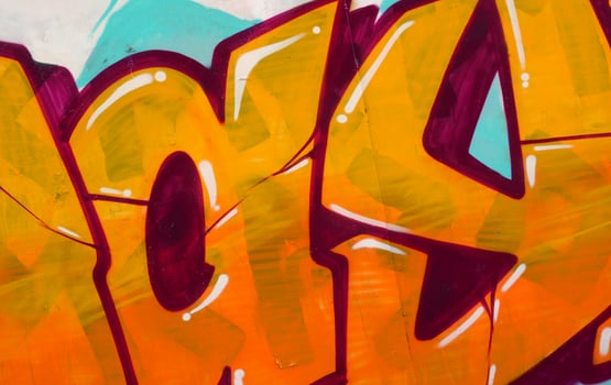 Colorful background of graffiti painting artwork with bright aerosol outlines on wall. Old school street art piece made with aerosol spray paint cans. Contemporary youth culture photo
