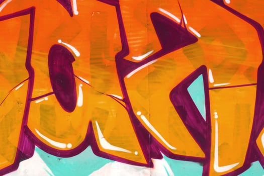 Colorful background of graffiti painting artwork with bright aerosol outlines on wall. Old school street art piece made with aerosol spray paint cans. Contemporary youth culture photo