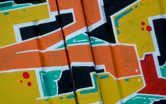 Colorful background of graffiti painting artwork with bright aerosol outlines on wall. Old school street art piece made with aerosol spray paint cans. Contemporary youth culture photo