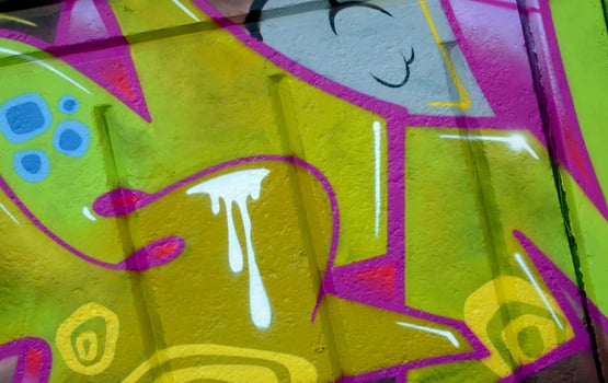 Colorful background of graffiti painting artwork with bright aerosol outlines on wall. Old school street art piece made with aerosol spray paint cans. Contemporary youth culture photo