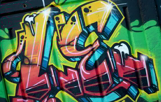 Colorful background of graffiti painting artwork with bright aerosol outlines on wall. Old school street art piece made with aerosol spray paint cans. Contemporary youth culture photo