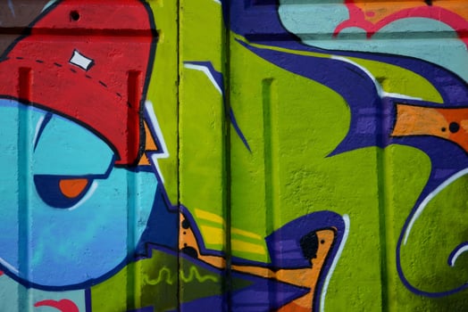 Colorful background of graffiti painting artwork with bright aerosol outlines on wall. Old school street art piece made with aerosol spray paint cans. Contemporary youth culture photo