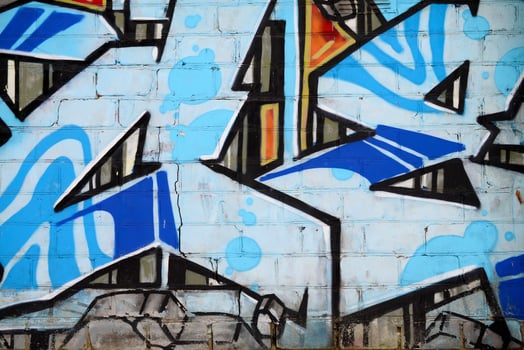 Colorful background of graffiti painting artwork with bright aerosol outlines on wall. Old school street art piece made with aerosol spray paint cans. Contemporary youth culture photo