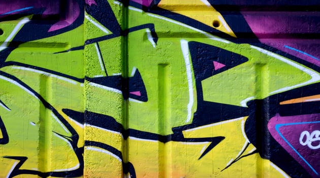 Colorful background of graffiti painting artwork with bright aerosol outlines on wall. Old school street art piece made with aerosol spray paint cans. Contemporary youth culture photo