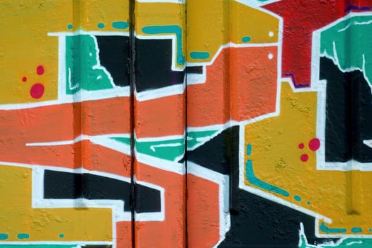 Colorful background of graffiti painting artwork with bright aerosol outlines on wall. Old school street art piece made with aerosol spray paint cans. Contemporary youth culture photo