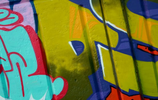 Colorful background of graffiti painting artwork with bright aerosol outlines on wall. Old school street art piece made with aerosol spray paint cans. Contemporary youth culture photo