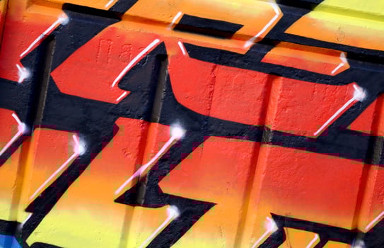 Colorful background of graffiti painting artwork with bright aerosol outlines on wall. Old school street art piece made with aerosol spray paint cans. Contemporary youth culture photo