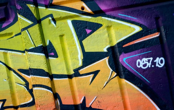 Colorful background of graffiti painting artwork with bright aerosol outlines on wall. Old school street art piece made with aerosol spray paint cans. Contemporary youth culture photo