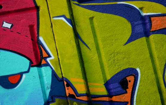 Colorful background of graffiti painting artwork with bright aerosol outlines on wall. Old school street art piece made with aerosol spray paint cans. Contemporary youth culture photo